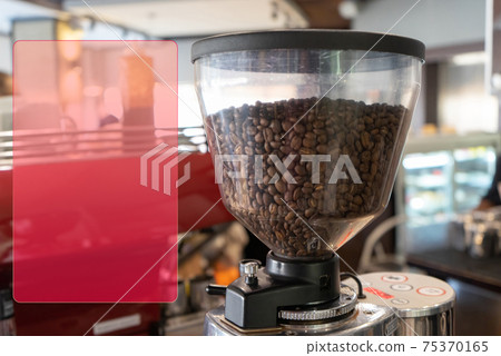 The top part of a professional grinder with more aromatic coffee beans The top part of a professional grinder with more aromatic coffee beans 75370165