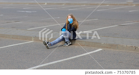 Portrait of sad caucasian child in face mask on closed playground outdoor. Coronavirus social distance quarantine. Portrait of sad caucasian child in face mask on closed playground outdoor. Coronavirus social distance quarantine. 75370785