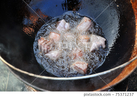 Meat in a cauldron. Meat in a cauldron. 75371237