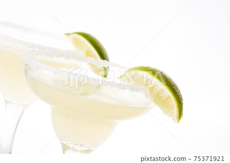 Margarita cocktail with lime in glass isolated on white background Margarita cocktail with lime in glass isolated on white background 75371921