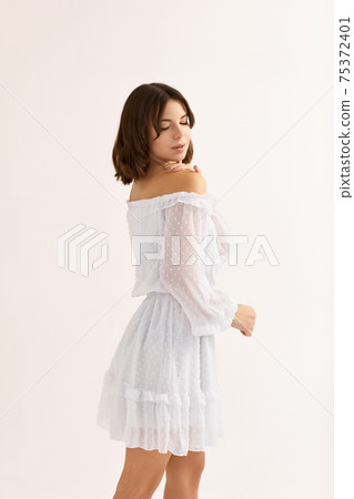 beautiful young brunette woman in white dress beautiful young brunette woman in white dress 75372401