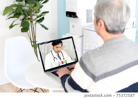 Senior (elderly) men receiving online medical treatment on a personal computer 75372587
