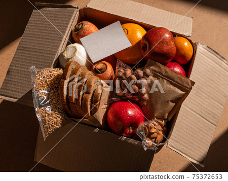 Healthy food delivery flat lay harsh shadows. Take away natural organic products.Donation box New normal online shopping Healthy food delivery flat lay harsh shadows. Take away natural organic products.Donation box New normal online shopping 75372653