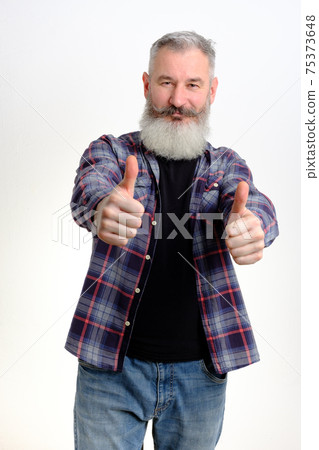 Studio portrait mature man dressed in casual clothes shows thumbs up, successful concept, white background 75373648