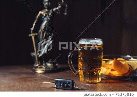 Drunk driving concept. Lady of justice, glass of beer and car key Drunk driving concept. Lady of justice, glass of beer and car key 75373810