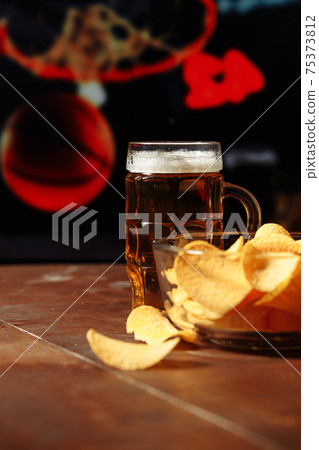 Television, TV watching basketball gamewith snacks and glass of beer. Vertical image Television, TV watching basketball gamewith snacks and glass of beer. Vertical image 75373812