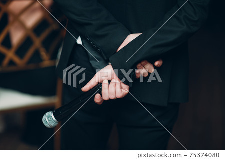 Man Showman Speaker Holding Microphone Behind His Back Business Conference Concept 75374080