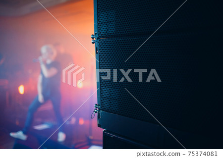 Nightclub Rock Concert Concept Big Stage Audio Speaker In The Foreground And Singer Musician Blurred On Background Nightclub Rock Concert Concept Big Stage Audio Speaker In The Foreground And Singer Musician Blurred On Background 75374081