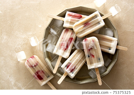 Fruit berry ice cream. Homemade popsicle loly with strawberries, blueberries and bananas. Summer dessert. 75375325