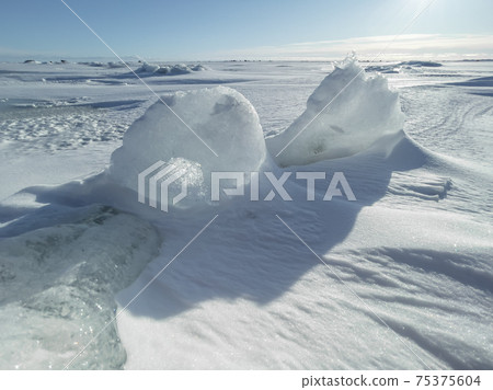 Ice slopes in sunny winter day, transparent ice of blue color, purely blue sky, long shadows, a pure snow-covered virgin soil, snow barkhans, Ice slopes in sunny winter day, transparent ice of blue color, purely blue sky, long shadows, a pure snow-covered virgin soil, snow barkhans, 75375604
