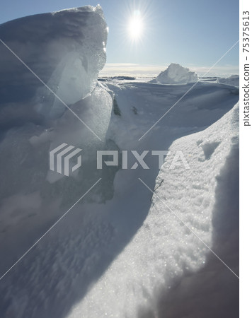 Ice slopes in sunny winter day, transparent ice of blue color, purely blue sky, long shadows, a pure snow-covered virgin soil, snow barkhans, Ice slopes in sunny winter day, transparent ice of blue color, purely blue sky, long shadows, a pure snow-covered virgin soil, snow barkhans, 75375613