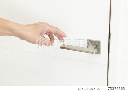 Hand touching the doorknob 75376563