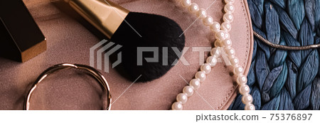 Jewellery and makeup tools inside a womans purse, beauty and fashion 75376897