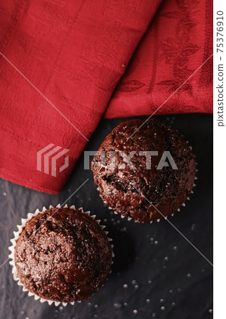 Two chocolate muffins freshly baked at home, homemade comfort food recipe Two chocolate muffins freshly baked at home, homemade comfort food recipe 75376910