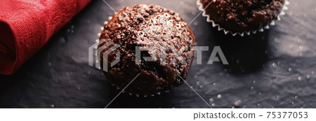 Two chocolate muffins freshly baked at home, homemade comfort food recipe Two chocolate muffins freshly baked at home, homemade comfort food recipe 75377053