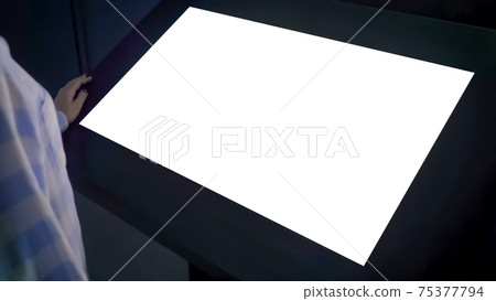 Woman looking at blank white display kiosk at exhibition - white screen concept Woman looking at blank white display kiosk at exhibition - white screen concept 75377794