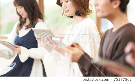 Young woman using tablet and touch pen 75377862