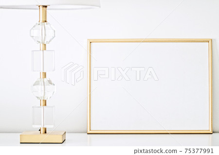 Golden frame for art, poster or photo in white interior, home decor 75377991