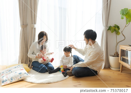 Happy family playing at home 75378017