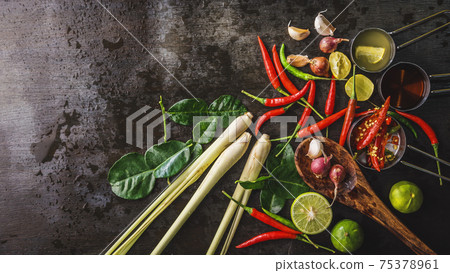 Spices for use as cooking ingredients on a wooden background with Fresh vegetables. Healthy food herbs. Organic vegetables on the table. Raw materials of cooking preparation Tom Yum. Spices for use as cooking ingredients on a wooden background with Fresh vegetables. Healthy food herbs. Organic vegetables on the table. Raw materials of cooking preparation Tom Yum. 75378961