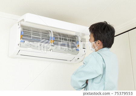 Workers inspecting air conditioners Workers inspecting air conditioners 75379553