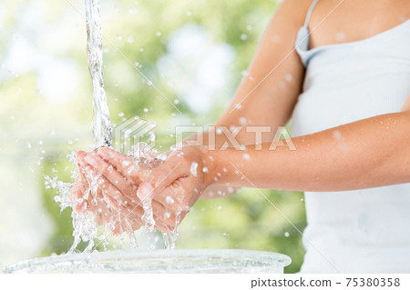 Woman bathing in water 75380358