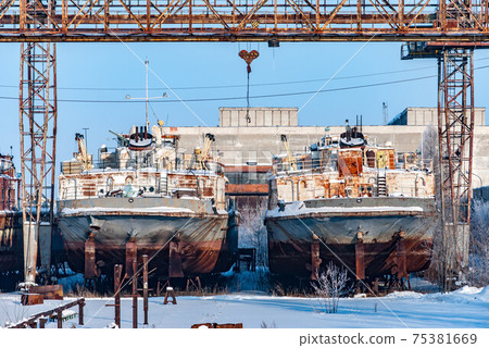 Rusty ships in snowy port in winter 75381669