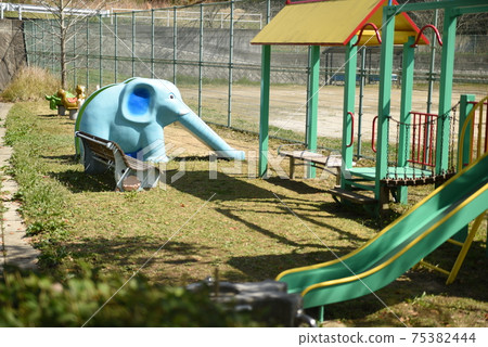 Jungle gym and slide in the city park 75382444