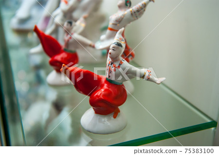 Assortment of rare porcelain figurines on glass shelf Assortment of rare porcelain figurines on glass shelf 75383100