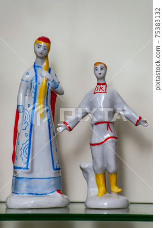 Assortment of rare porcelain figurines on glass shelf Assortment of rare porcelain figurines on glass shelf 75383132