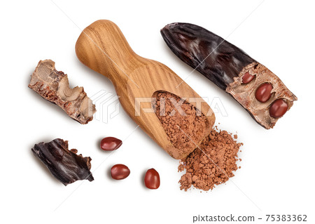 Carob pod and powder in wooden scoop isolated on white background with clipping path. Top view. Flat lay Carob pod and powder in wooden scoop isolated on white background with clipping path. Top view. Flat lay 75383362