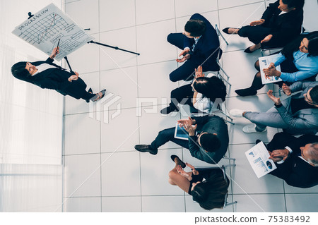 businesswoman asks questions during a business presentation businesswoman asks questions during a business presentation 75383492