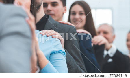 close up. a group of young professionals supporting each other. close up. a group of young professionals supporting each other. 75384149