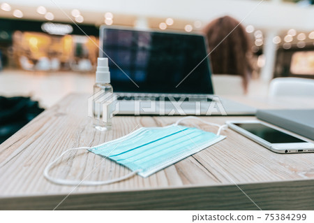 protective mask, smartphone and laptop on the table protective mask, smartphone and laptop on the table 75384299