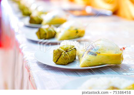 Thai curry in a plastic bag, a polypropylene bag is placed on a white dish, coupled with a bunch of boiled rice and steamed rice. Thai curry in a plastic bag, a polypropylene bag is placed on a white dish, coupled with a bunch of boiled rice and steamed rice. 75386458