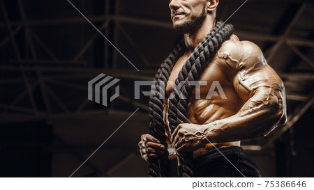 fitness athletes training using battle ropes 75386646