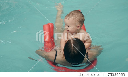 Mom and infant son in a water park 75386663