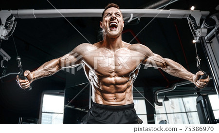 Strong bodybuilder man at the gym Strong bodybuilder man at the gym 75386970