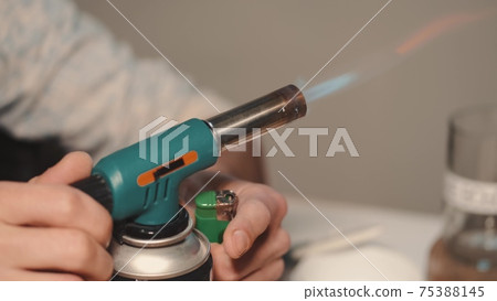 Man sticking the crative sticker on a hand-made glass in a workshop 75388145