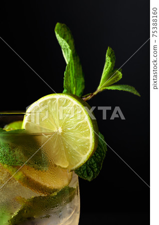 Frozen glass with a Mojito on a black background. 75388160