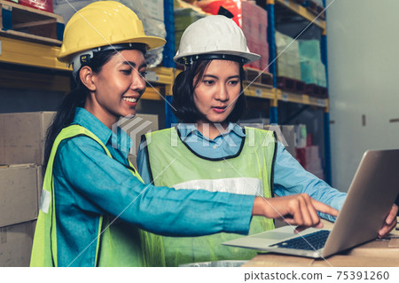 Female warehouse worker working at the storehouse 75391260