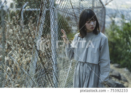 Woman walking in the park Woman walking in the park 75392233