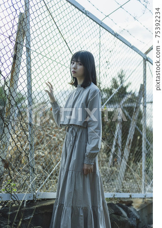 Woman walking in the park Woman walking in the park 75392234
