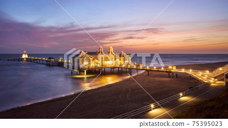 Panoramic view of pier in Sellin, Rugia (Ruegen) Baltic Coast island at purple sunrise, Germany. Panoramic view of pier in Sellin, Rugia (Ruegen) Baltic Coast island at purple sunrise, Germany. 75395023