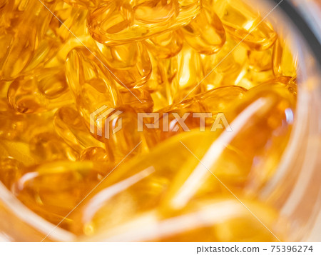 Yellow pills in drug bottle 75396274