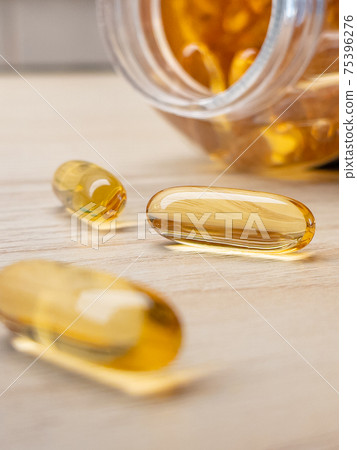 Yellow pills in drug bottle Yellow pills in drug bottle 75396276