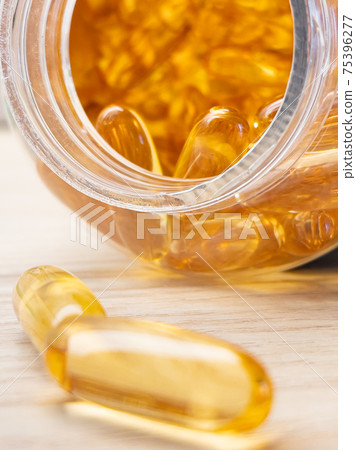 Yellow pills in drug bottle Yellow pills in drug bottle 75396277