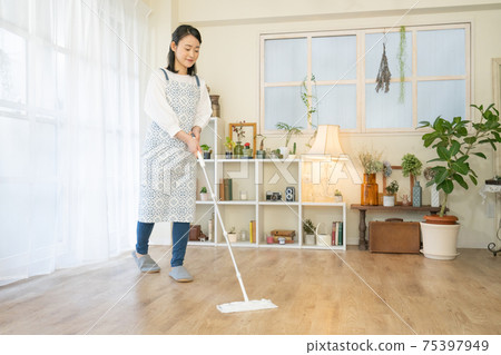 Cleaning Young woman wearing a flooring wiper Cleaning Young woman wearing a flooring wiper 75397949
