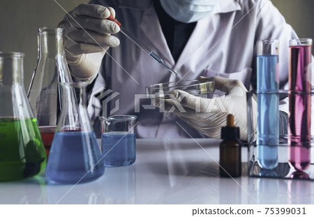 Medicine doctor with syringe in hand. Healthcare and medical concept. Medicine doctor with syringe in hand. Healthcare and medical concept. 75399031
