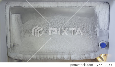 freezer of a refrigerator. Ice buildup inside of a freezer walls. freezer of a refrigerator. Ice buildup inside of a freezer walls. 75399033